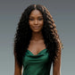 AA long curly synthetic lace front wig – Woman with long, wavy curly hair wearing a green dress against a gray background