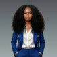 Woman wearing a blue suit with a white shirt on a gray background