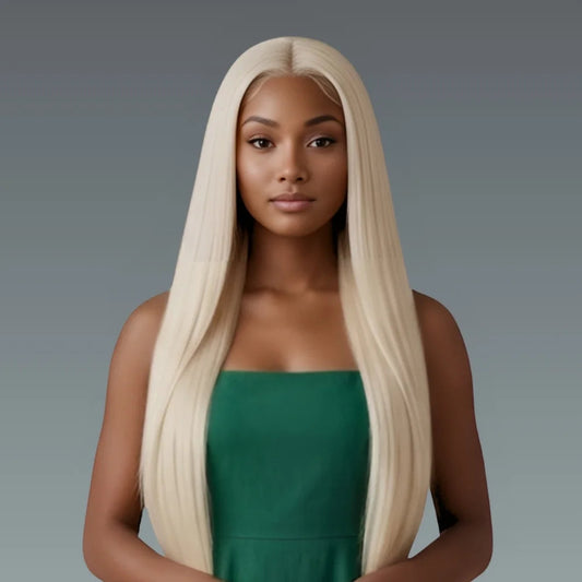 Woman with long blonde wig wearing a green dress against a gray background
