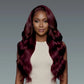 Woman with long, wavy burgundy hair against a gray background