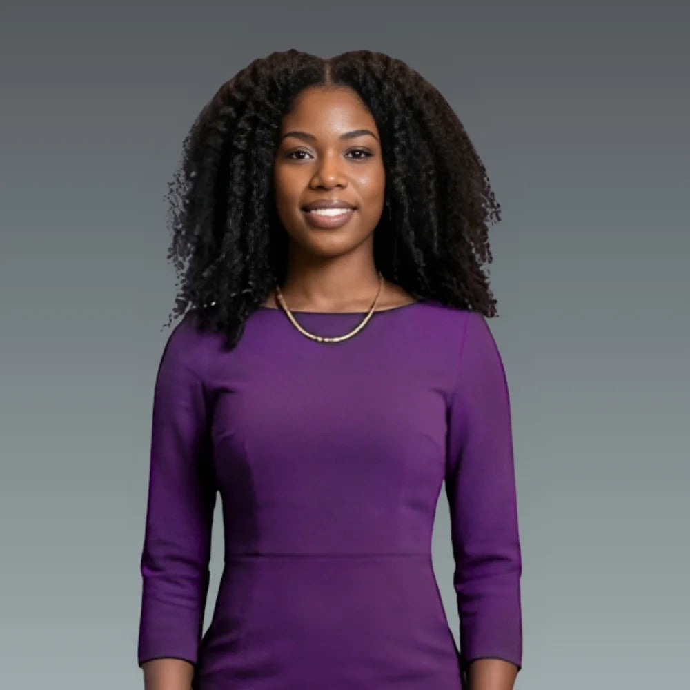 Woman wearing a purple dress against a gray background