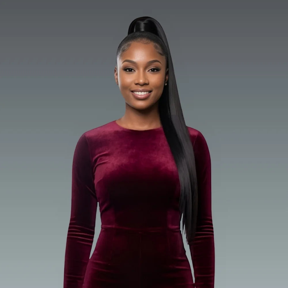 Woman wearing a burgundy velvet dress against a gray background