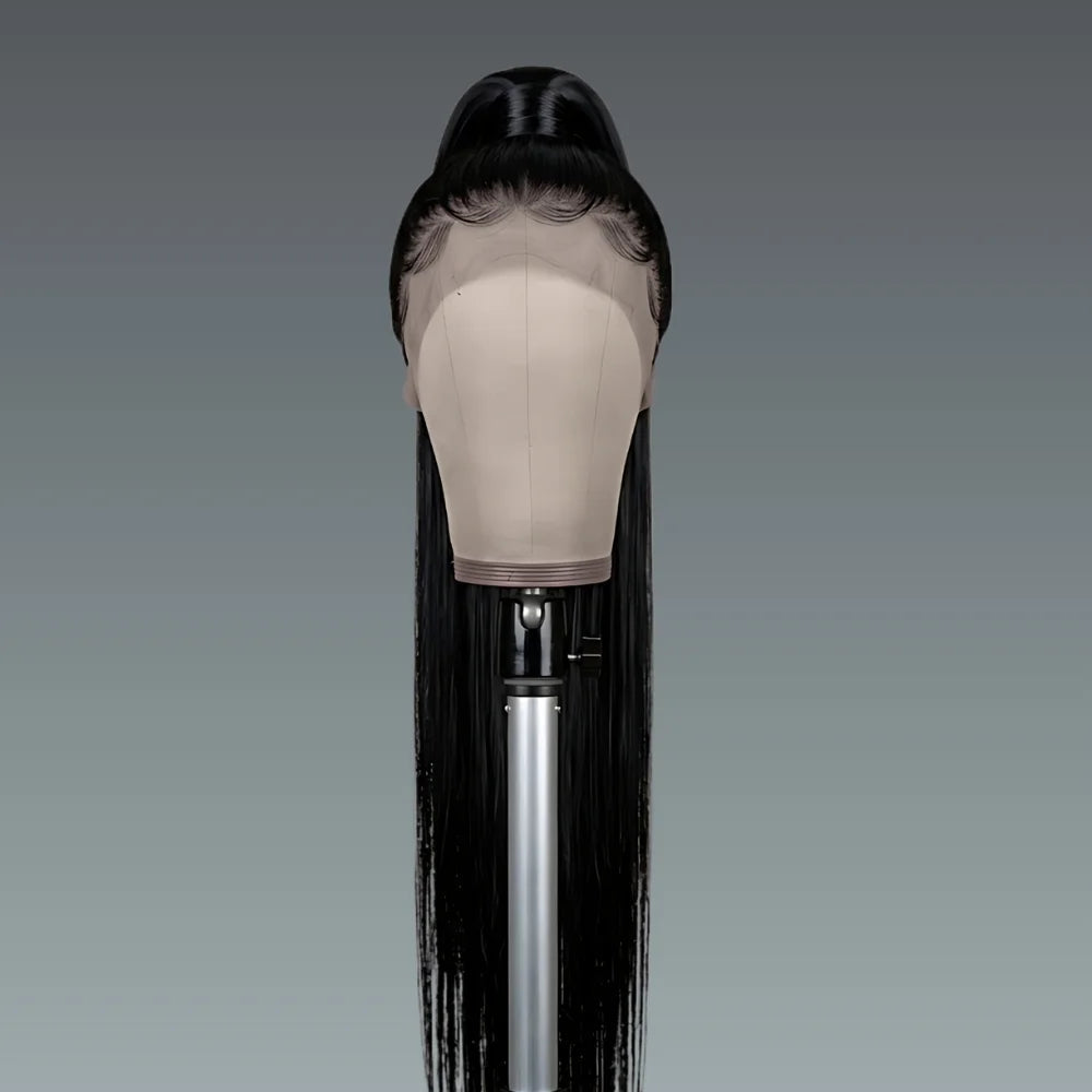 Black wig on a mannequin head against a gray background