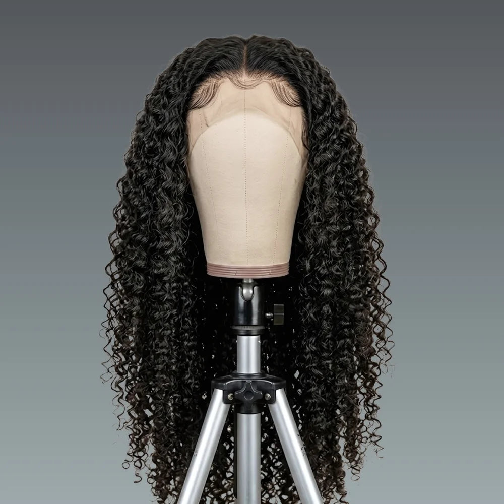 Black curly wig on a mannequin head against a gray background