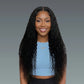 Woman with long, curly black hair wearing a light blue top against a gray background