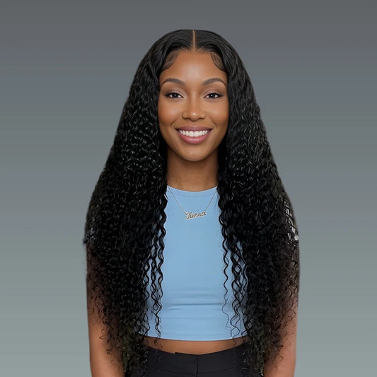 Woman with long, curly black hair wearing a light blue top against a gray background