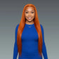 Woman with long orange hair wearing a blue top against a gray background