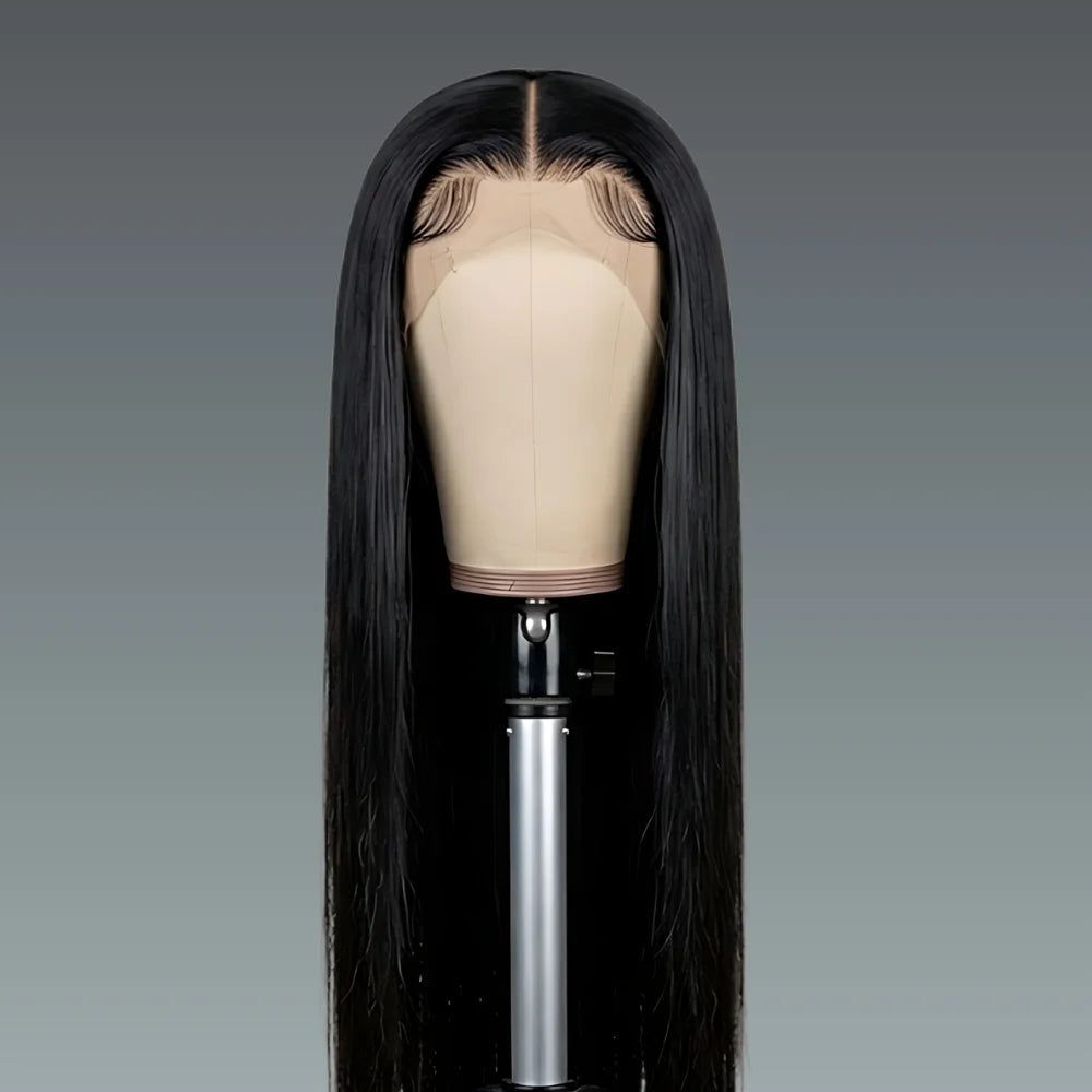 Black straight wig on a mannequin head against a gray background