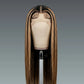 Brown wig on a mannequin head against a gray background