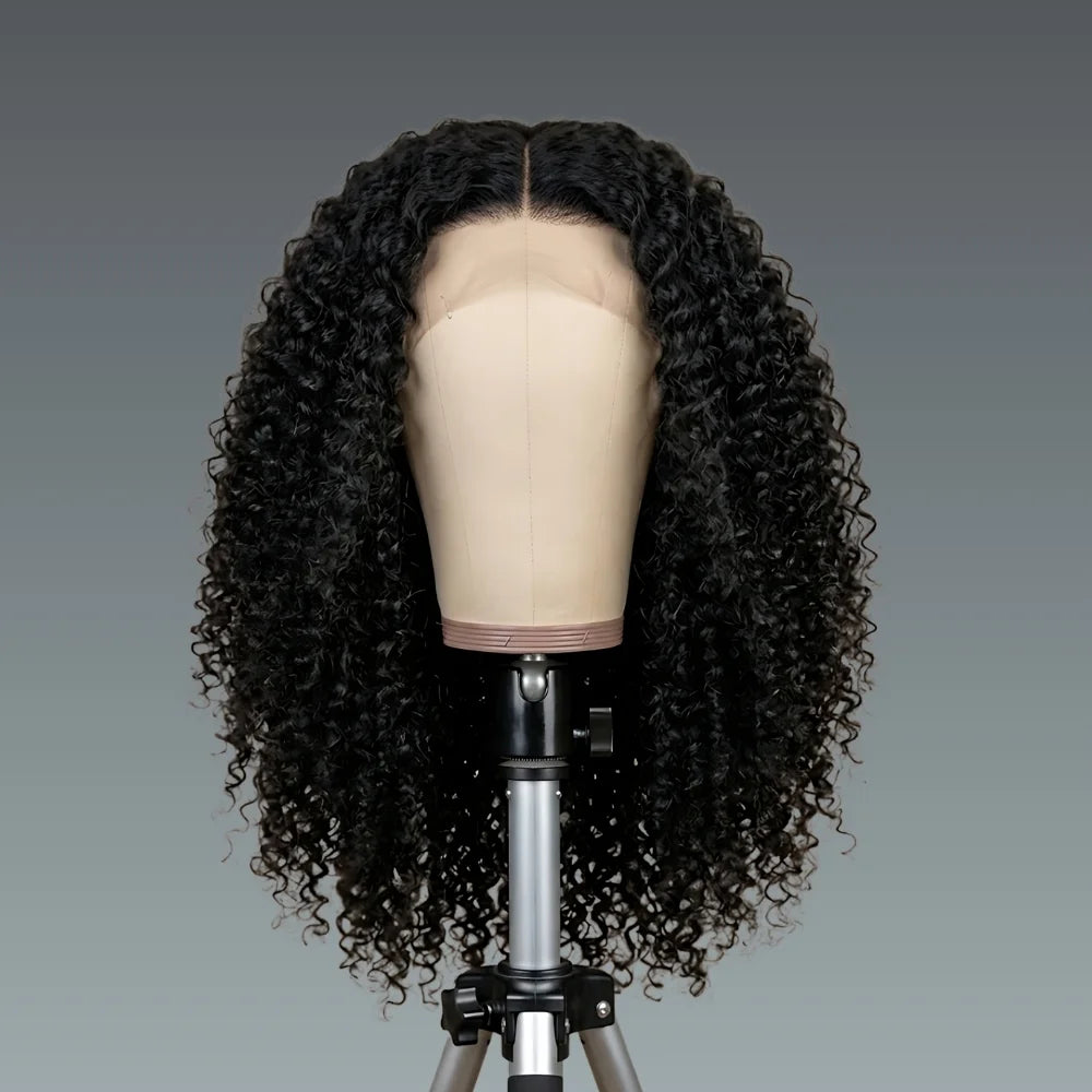 Black curly wig on a mannequin head against a gray background