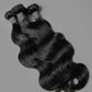 Three Brazilian body wave human hair bundles laid flat on a grey background