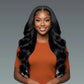 Woman with long black hair wearing an orange top on a gray background